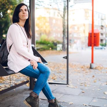 Woman waiting for bus to work