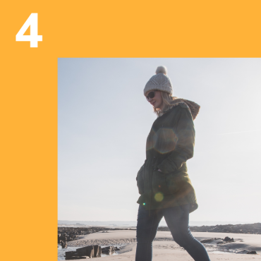 Photo of woman walking on beach