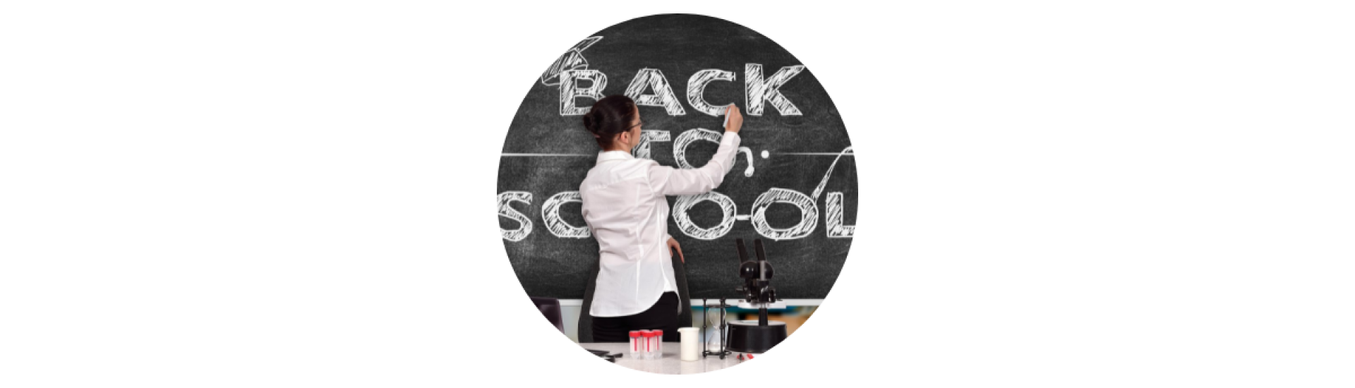 Photo of a teacher writing back to school on a blackboard