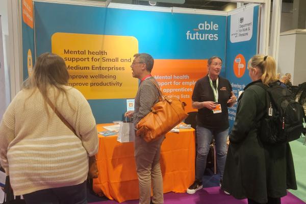 People standing and talking at an exhibition stand