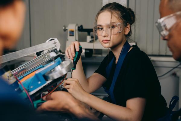 Young apprentice looking thoughtful while while engineering